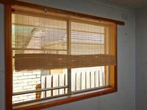 Half raised matchstick blinds on a lounge room window