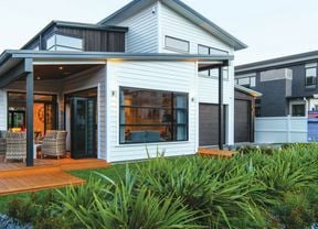 A completed home at the front of a row of similar completed homes