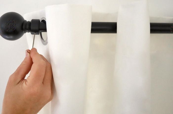 Attaching a finial to the end of a curtain rod