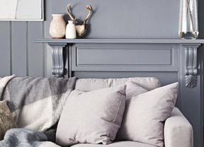 Couch with grey colour palette walls behind.
