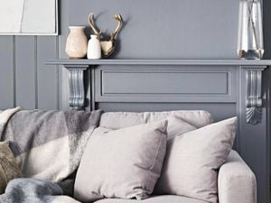 Couch with grey colour palette walls behind.