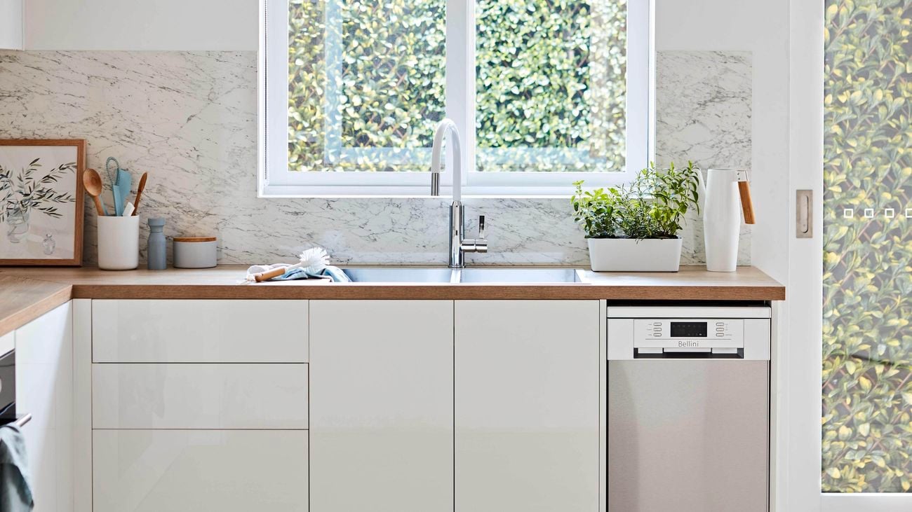 Scandi style kitchen with white cabinetry and timber finishes.