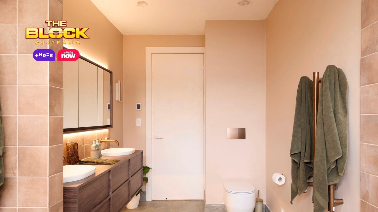 Natural coloured brown bathroom with timber vanity with towel rails and toilet