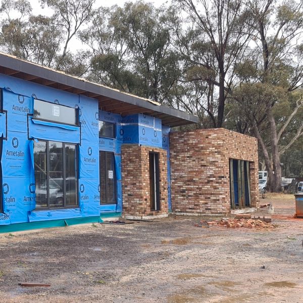 Half bricked up house in construction with walls being completed