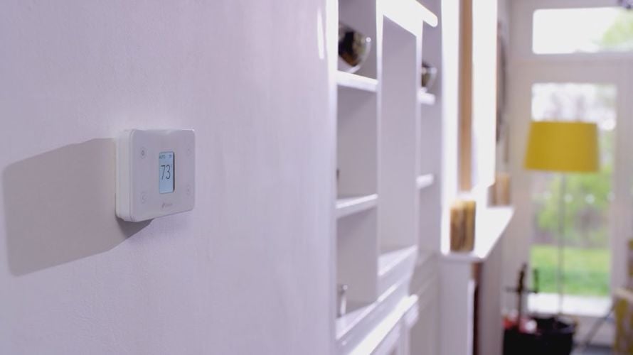 Digital thermostat attached to wall