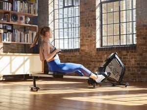 Woman rowing on a rowing machine