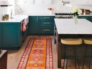 L-shaped kitchen benches in dark green with a separate island bench