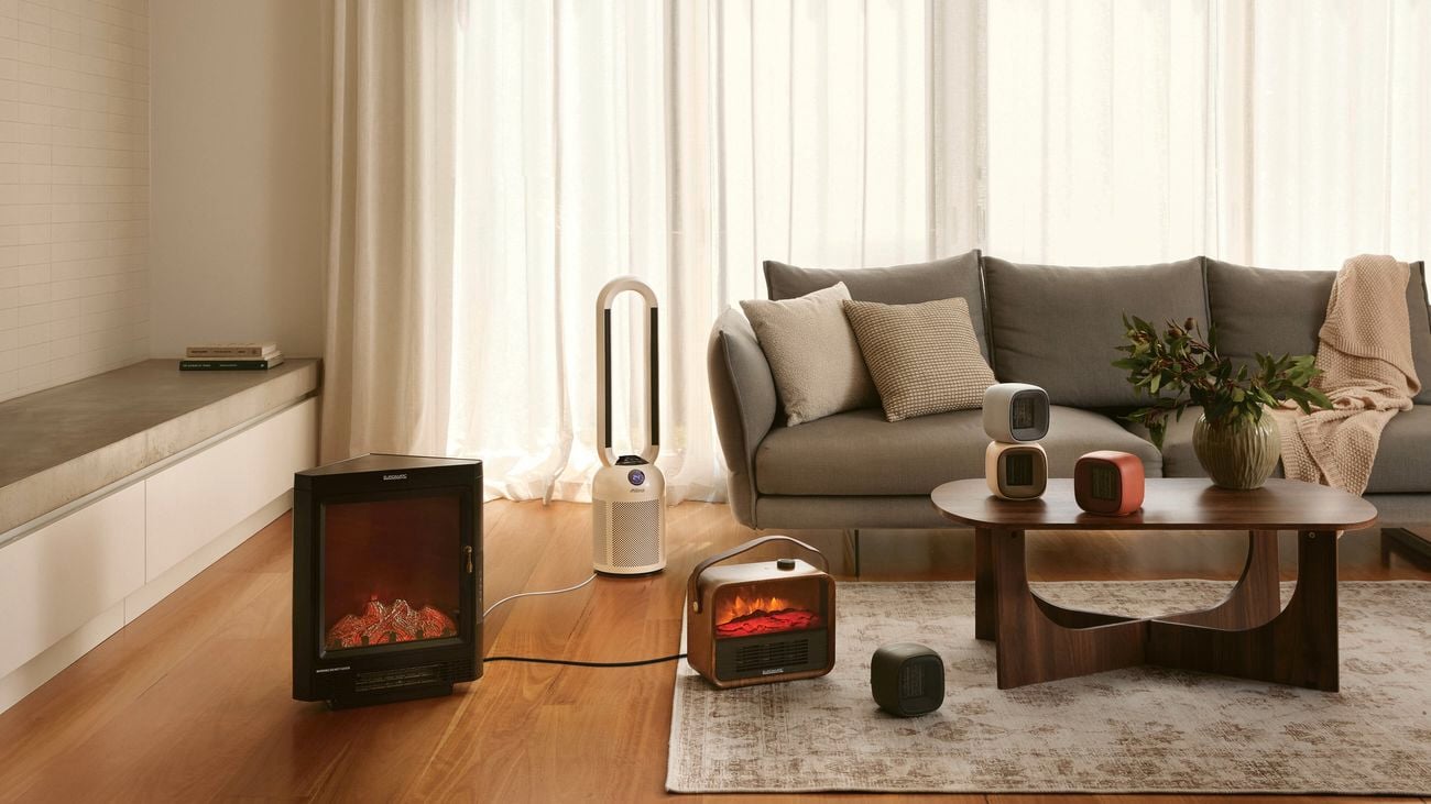 A modern furnished lounge room with timber flooring in it.
