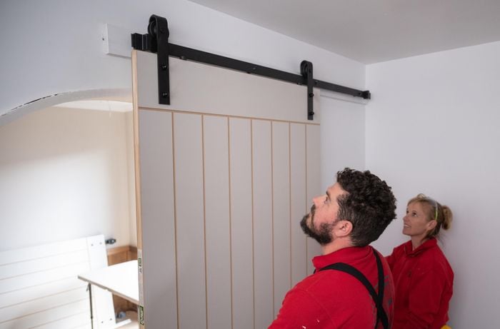 Team members hanging the door.