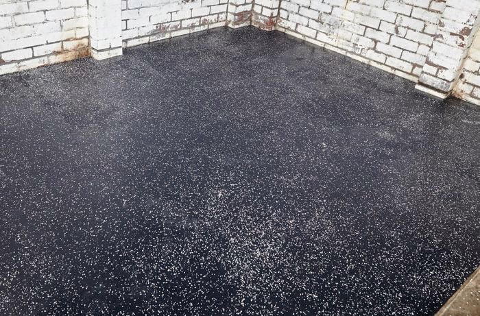 Restored garage floor with grey epoxy floor coating.