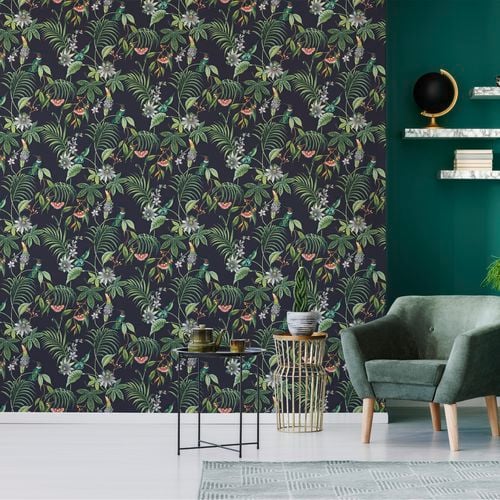 Room with tropical wallpaper, green chair, green wall and coffee tables.