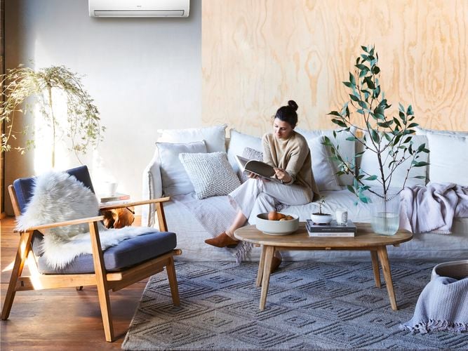 woman in a Lounge room styled with warm tones reading soemthing