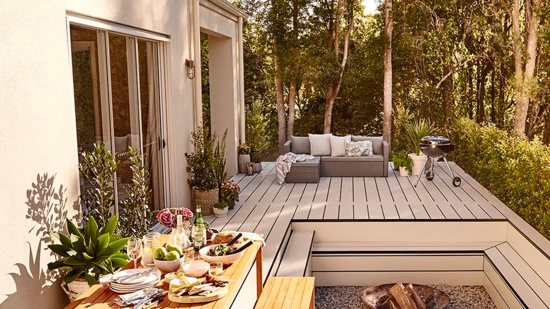 Outdoor deck with fire pit and table of food
