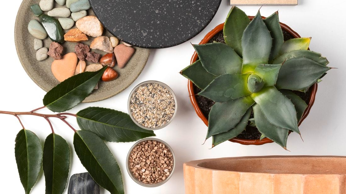 Mixture of pavers, plants, pebbles and pots