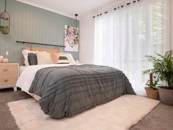 Beige rug in a bedroom setting.