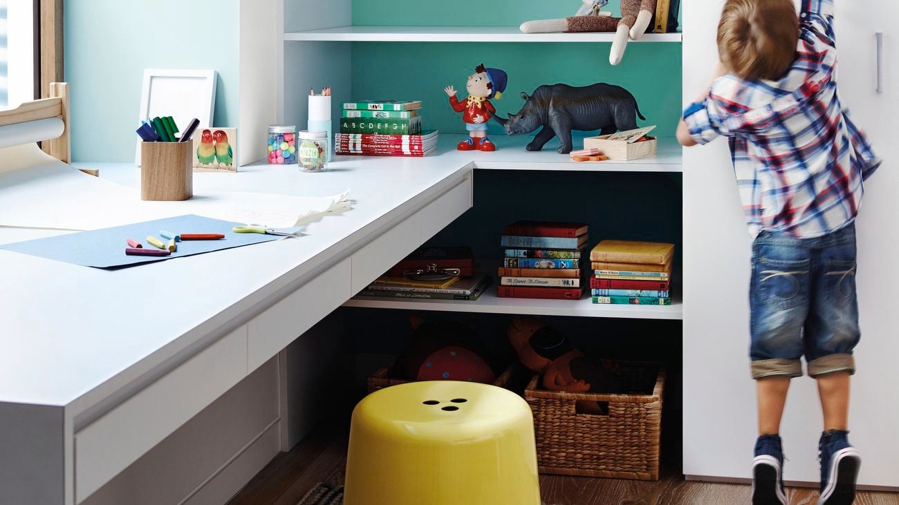Kids desk surrounded by toys and children’s books