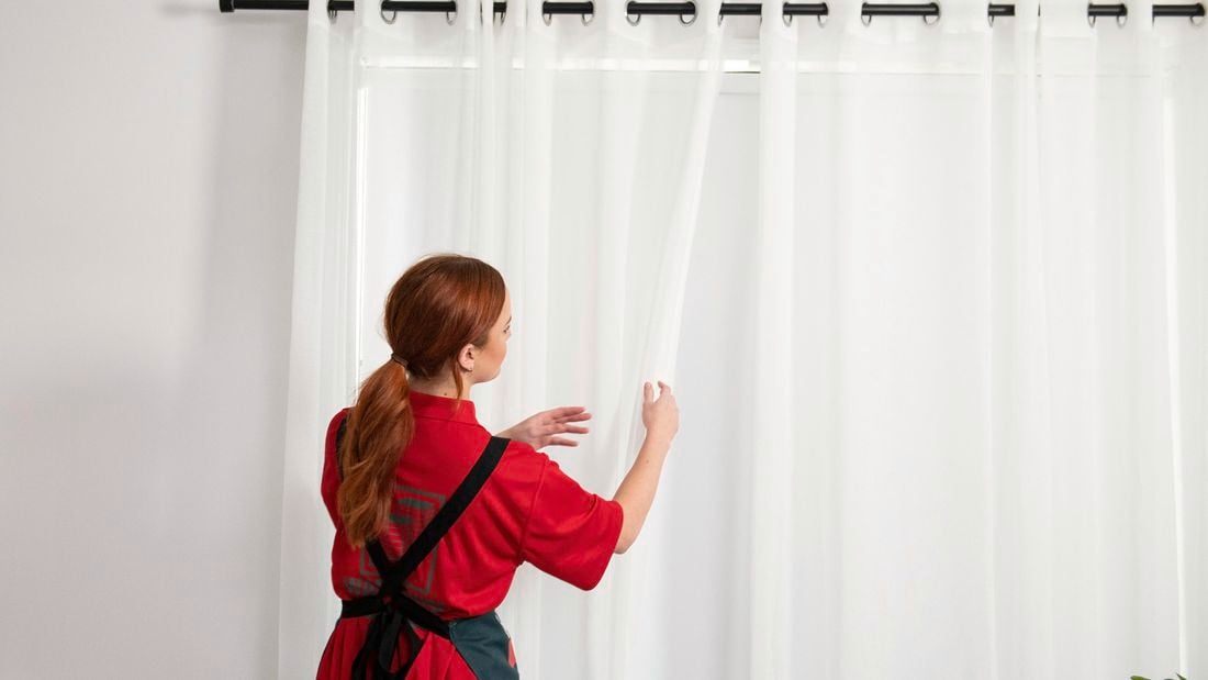 Bunnings Team Member opening curtains in a bedroom.