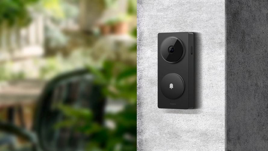 Aqara smart video doorbell mounted beside an entrance