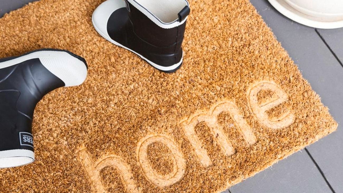 Door mat with gumboots on it.