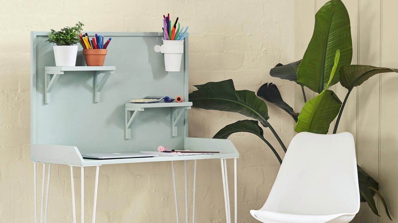 A green kids workstation with a plastic white chair.