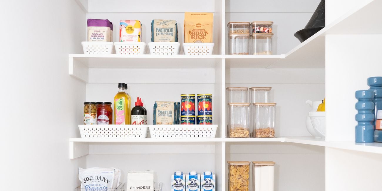 Kitchen pantry with white shelving, neatly displayed with white storage containers