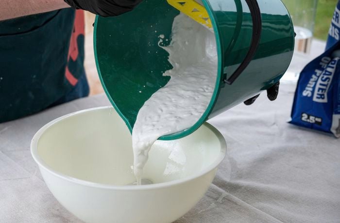 pouring plaster mixture into a bowl