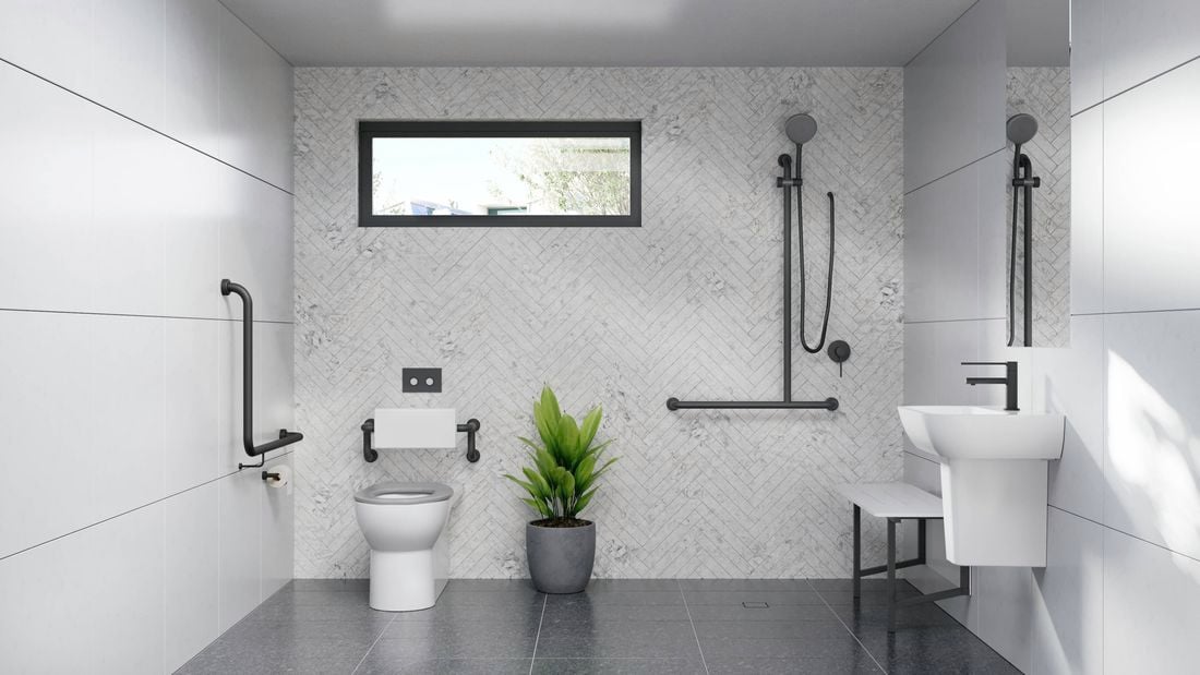 A white and grey toned bathroom fitted with assisted living products
