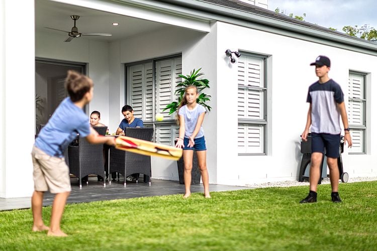 Family playing backyard cricket