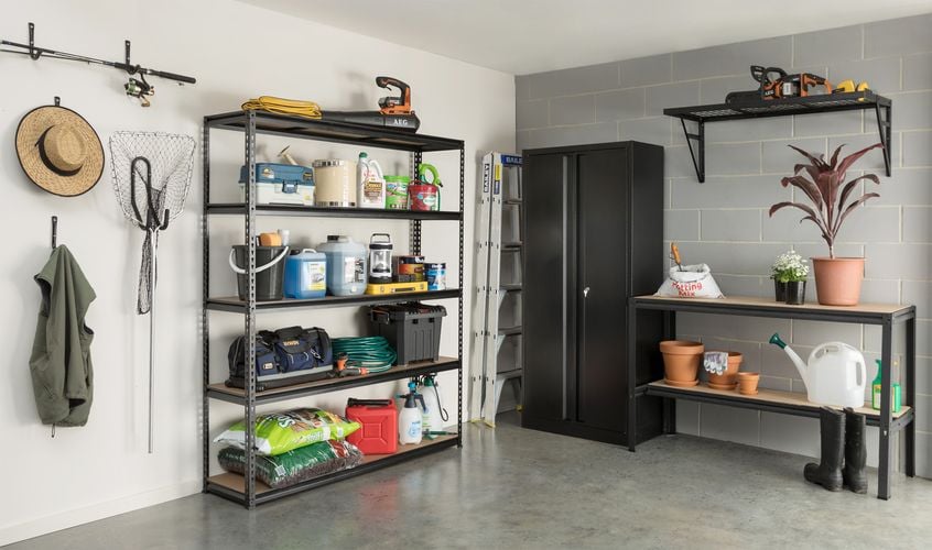 Garage featuring a collections of Pinnacle shelving, cabinets and storage hooks.