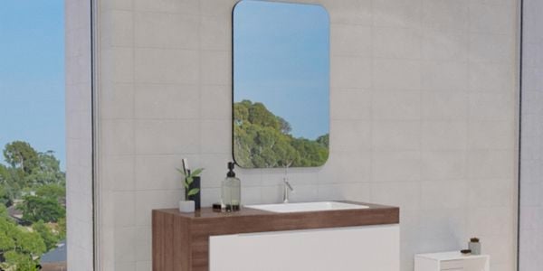 Bathroom with mirror along with wash basin, white wall tiles and storage shelf.