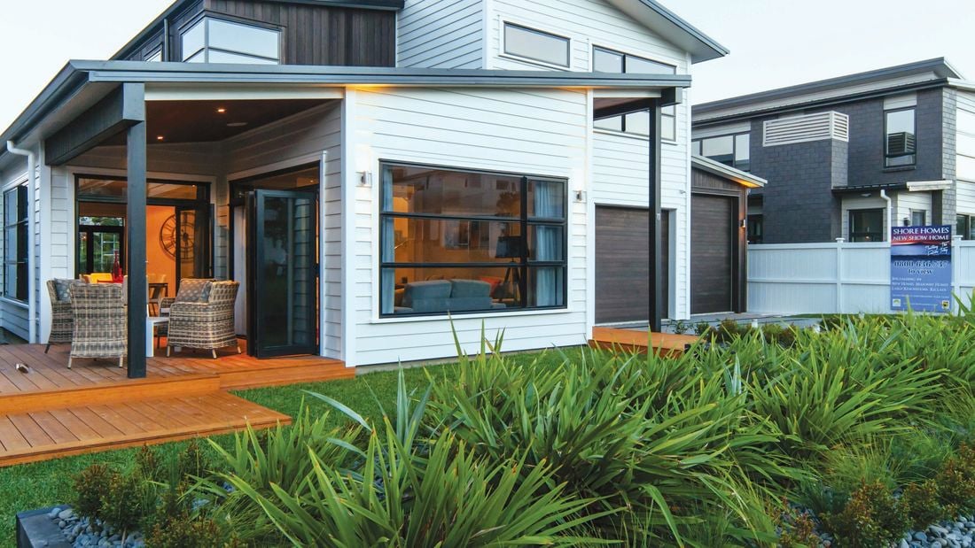 A completed home at the front of a row of similar completed homes