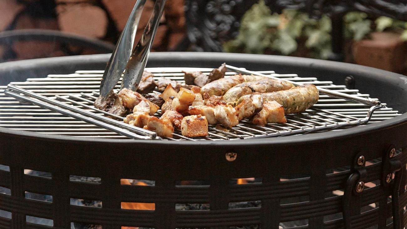 Food being barbecued on a lit, Glow fire pit