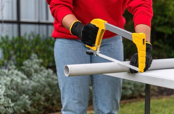 using hacksaw to cut pvc pipe