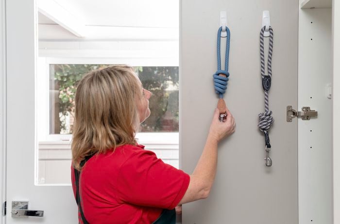 Hooks on back of door with items hanging.