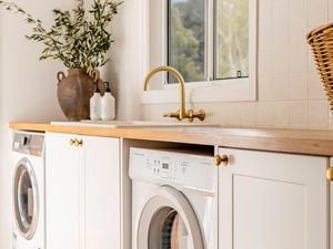 Farmhouse laundry makeover, timber bench tops with washing machine and dryer siting under bench top