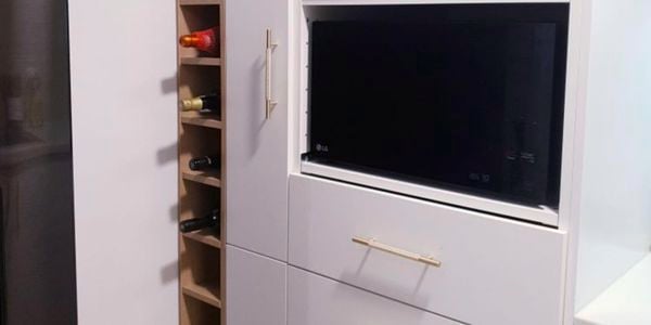 A vertical wine rack next to kitchen cabinets