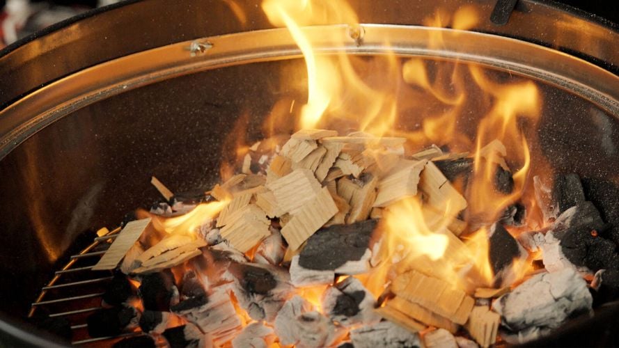 Smoking Chips alight ontop of coals in BBQ kettle