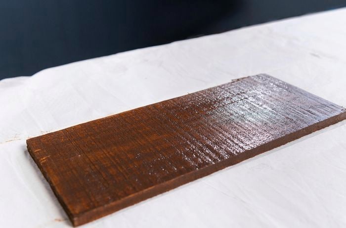 Painted timber drying on white cloth
