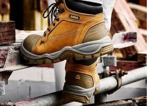 A pair of DeWALT Akron Safety Tradie Boots being worn on a job site