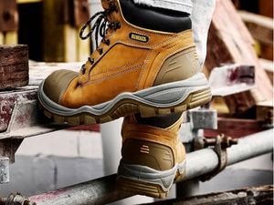 A pair of DeWALT Akron Safety Tradie Boots being worn on a job site