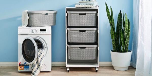 laundry cart in a laundry room with washing machine on the left