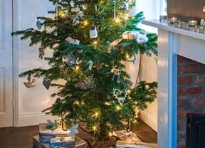 Decorated christmas tree with fairy lights and presents