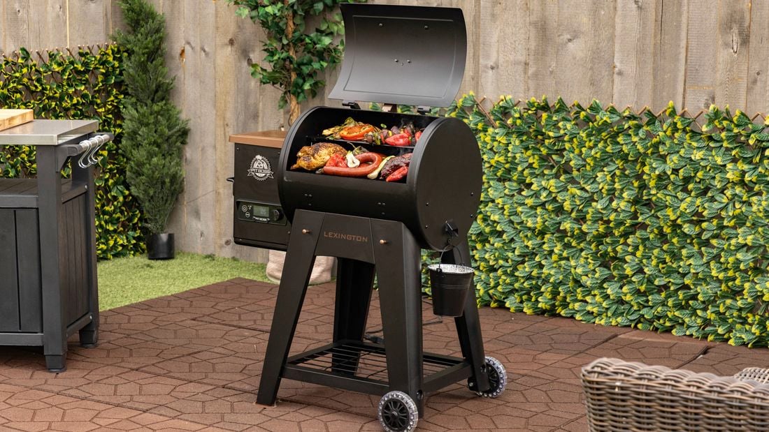 Pit Boss BBQ in yard with food cooking