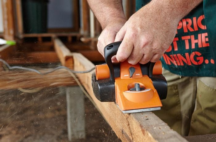 Bunnings team member planing a joist