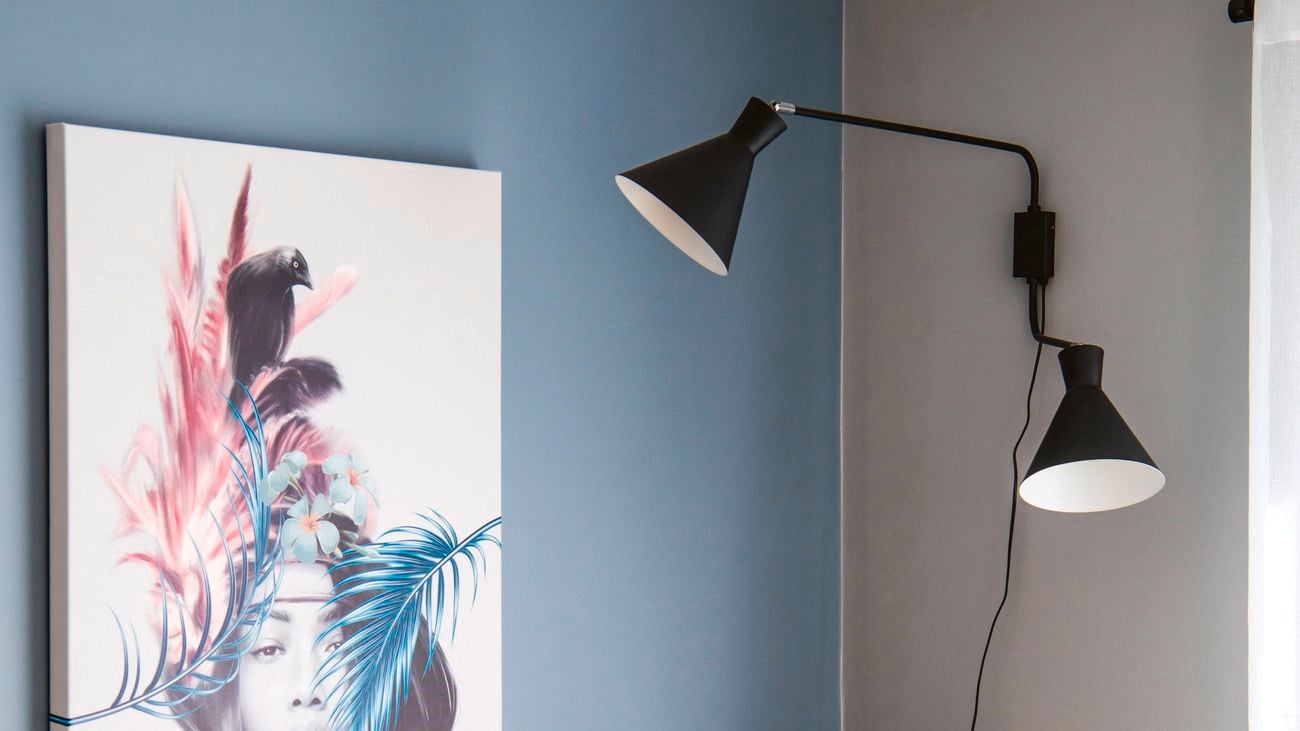 Adjustable wall mounted lamps above a reading corner