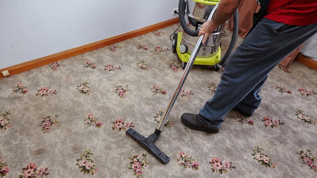 Bunnings team member vacuuming carpet