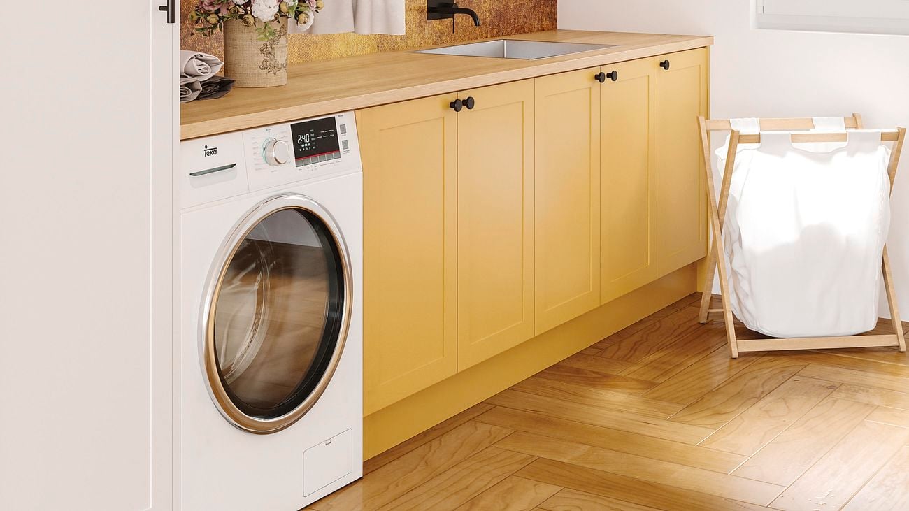 close up image with timber flooring, washing machine, overhead cupboards and washing hamper