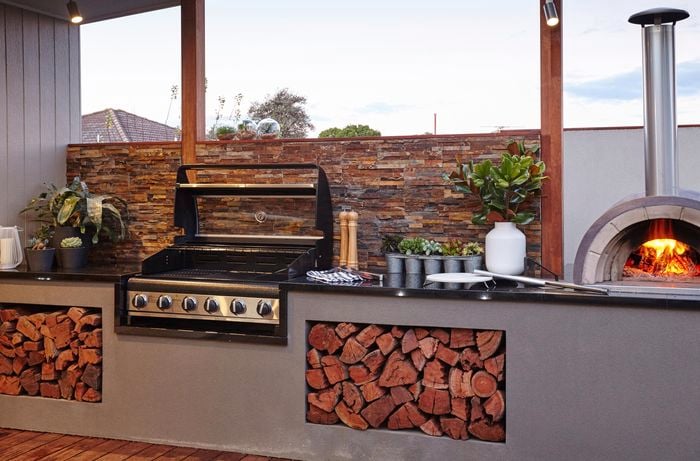 An outdoor room with wood-fired pizza oven and BBQ
