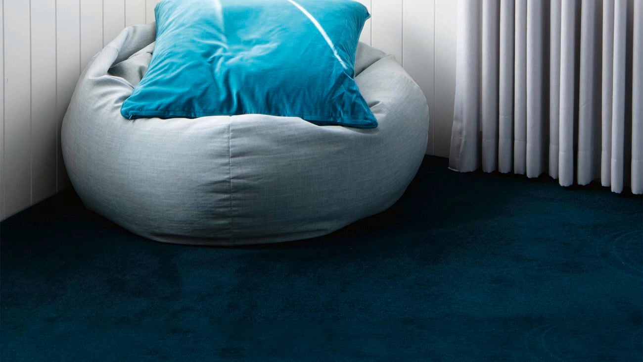 Carpet with grey bean bag on it