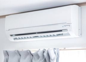 Split system air conditioner installed above the curtains.